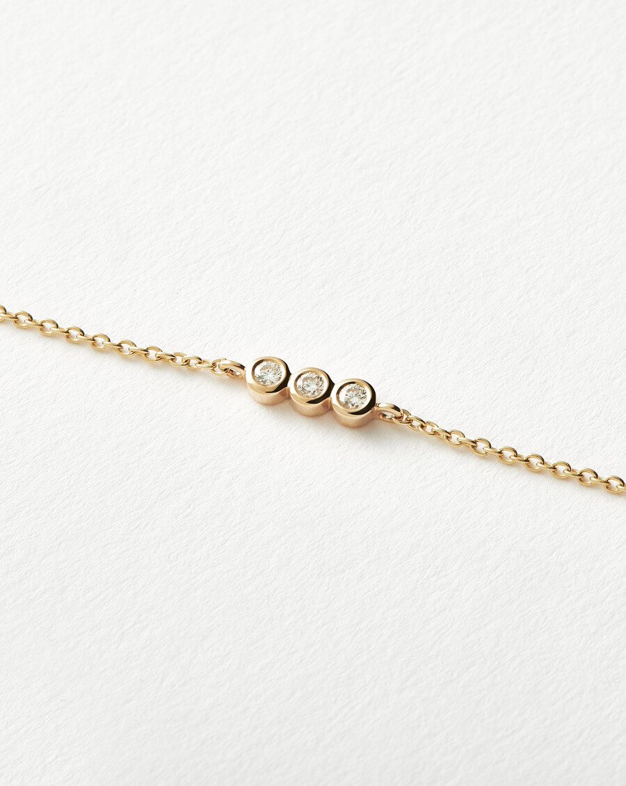 pulsera de tres solitarios de diamantes finos - oro