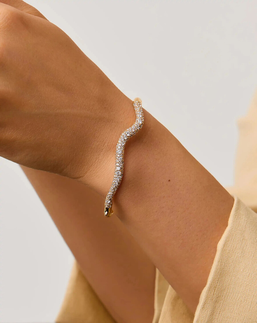 brazalete con bisagras de ondas de nieve fundida - oro