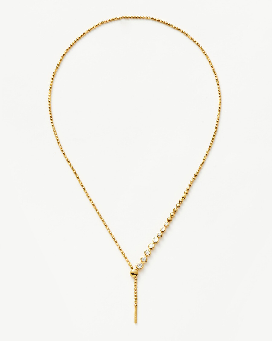 collar de oro con lazo y cuentas de piedra