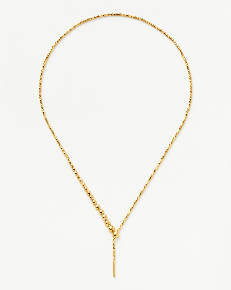 collar de oro con lazo y cuentas de piedra