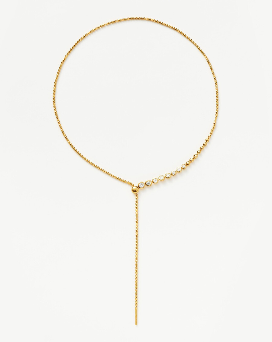 collar de oro con lazo y cuentas de piedra