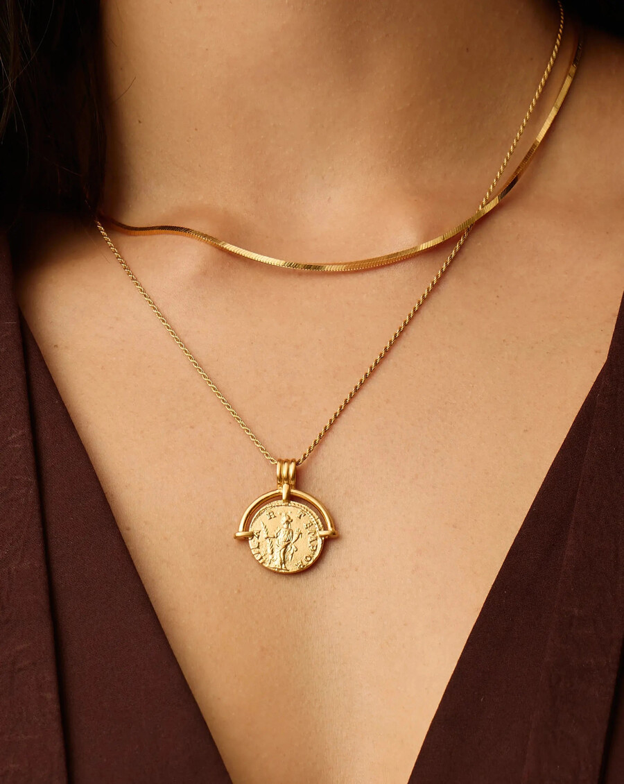 conjunto de collar dorado con arco romano y serpiente de lucy williams